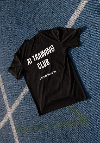 Black t-shirt with 'AI Training Club' text on a blue textured surface